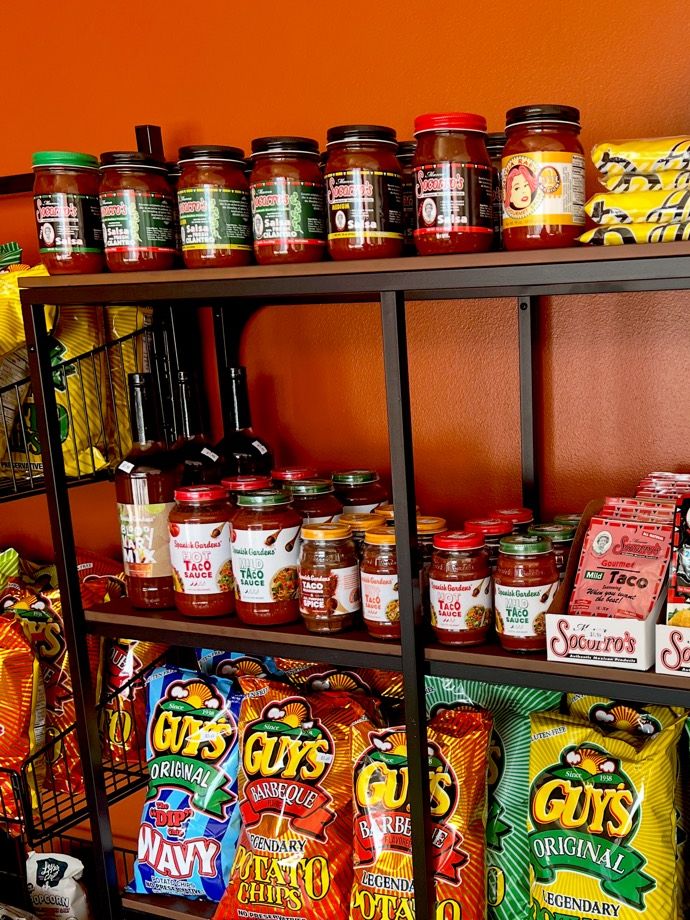 Jars of Mama Socorro’s salsa and Spanish Gardens taco sauce on the shelf